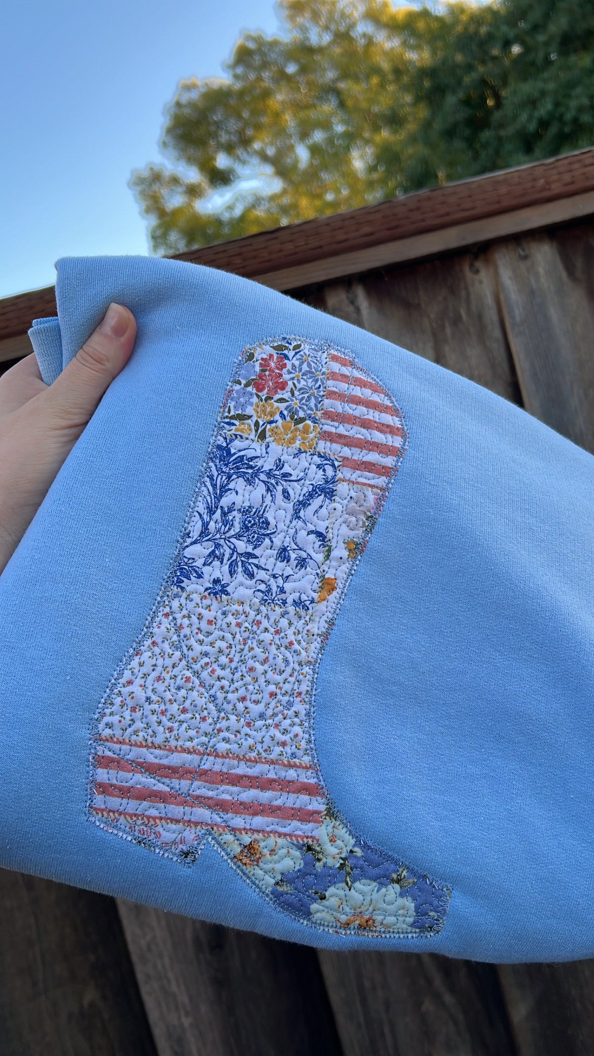 Handmade cowboy boot embroidered sweatshirt close-up